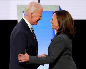 Former Vice President Biden and Senator Harris shake hands before the start of the second night...