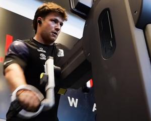 Finn Henry works on a grinder as he trains with Team New Zealand. PHOTO: YOUTUBE