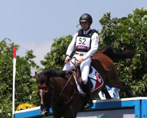 Robin Godel of Team Switzerland riding Jet Set clears a jump during the Eventing Cross Country...