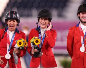Laura Kraut, Jessica Springsteen and McLain Ward of Team United States pose with their silver...