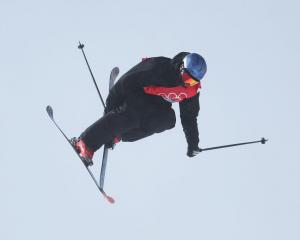 Nico Porteous performs a trick on his first run during the men's skiing halfpipe final at the...