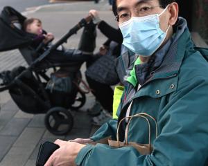 Microbiologist and bus user Siong Loo, of Dunedin, waits for the Shiel Hill bus at Dunedin’s bus...