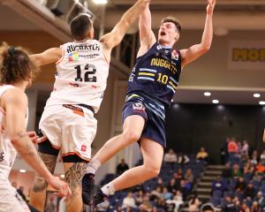 Nuggets guard Michael Harris goes up against Hawks defender Ethan Rusbatch during their National...