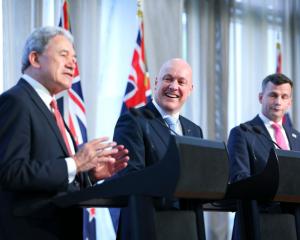 Prime Minister Christopher Luxon (centre) with deputy Winston Peters (right) and Act leader David...