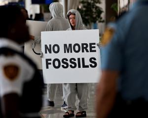 An activist protests at the United Nations Climate Change Conference COP28 in Dubai. Photo: Reuters