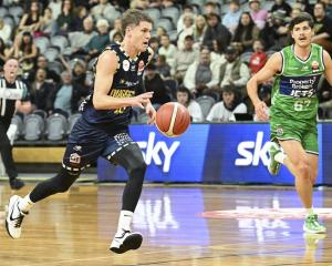 Otago Nuggets guard Ben Henshall takes the ball up court while chased by Manawatu Jets forward...