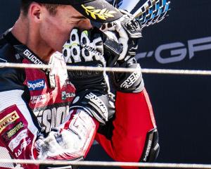 Southland motorcycle rider Cormac Buchanan hugs his trophy after finishing third in race two at...