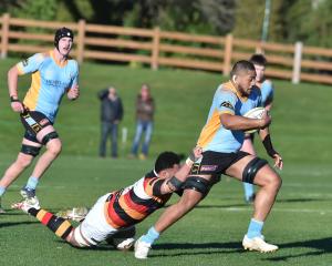 Club Rugby University lock Ale Aho tries to escape the tackle of Zingari No 8 Mika Mafi last...