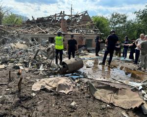 Ukraine police officers work at the site of a Russian air strike in Kharkiv. PHOTO: REUTERS