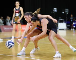 Steel centre Kate Heffernan (left) tries to steal the ball from Magic wing attack Claire O’Brien...