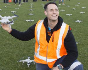 Drone Sky Shows NZ managing director Josh Van Ross holding up drone number 201, the lone drone...