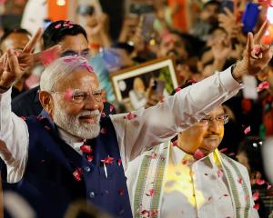 Indian Prime Minister Narendra Modi gestures as he arrives at Bharatiya Janata Party (BJP)...