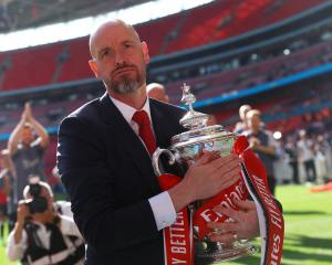 Manchester United's Erik ten Hag celebrates with the trophy after winning the FA Cup this year. ...