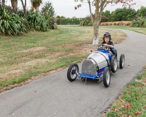 Five-year-old Benji Muckle of Ashburton takes the replica Bugatti pedal car for a spin ahead of...