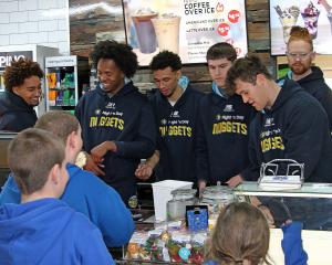 Youngsters swarmed to Essex St to meet the Otago Nuggets, including (from left) Dontae Russo...