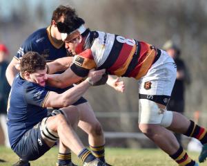 Dunedin lock Jamie Mowat (left) grabs Zingari-Richmond No 8, Tofatuimoana Solia, at Montecillo on...