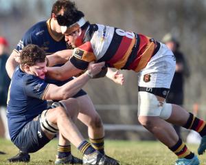 Dunedin lock Jamie Mowat tackles Zingari number 8 Tofatuimoana Solia during a Dunedin premier...