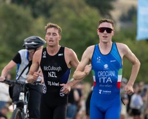 New Zealand triathlete Dylan McCullough (left) battles for the lead from Alessio Crociani, of...