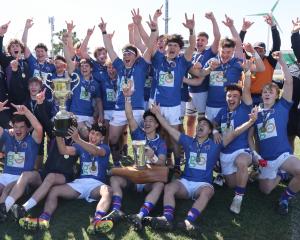 The Southland Boys’ First XV celebrate winning the national first XV title in Palmerston North...
