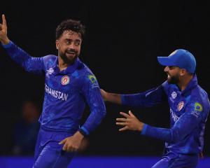 Afghanistan's Rashid Khan celebrates after dismissing New Zealand's Michael Bracewell. Photo: Getty