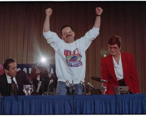 Terry Anderson raises his arms in triumph at a press conference. Anderson was just released by a...