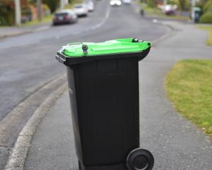 A green-lidded bin for food scraps and garden waste — due to be used in Dunedin from next month —...