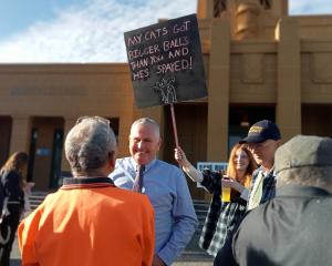 Protesters outside the Buller District Council meeting talk to Mayor Jamie Cleine. PHOTO: LISA...