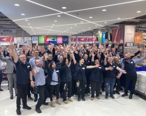 Kmart staff welcome customers with open arms at the new Dunedin store this morning. Photo:...