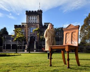 Larnach Castle sales and marketing manager Jo van der Linden with a rimu chair made for William...