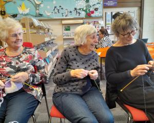 Experienced knitters Carol Watson (left) and Fay Yates (centre), of Observatory Village, teach...