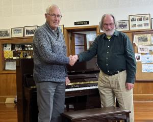Oamaru Variety Entertainment Club president Ray Walker (left) presents the club’s piano to Oamaru...