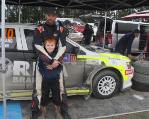 Jackson Strang, 7, of Wallacetown, is keen to help dad Carter Strang at a service stop at Winton....