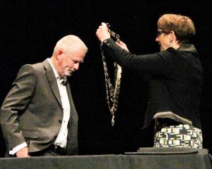 Invercargill Mayor Nobby Clark receives the mayoral chains from Invercargill city council chief...
