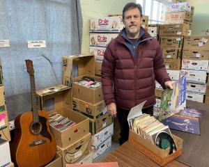 Regent Theatre Music &amp; Entertainment Sale co-ordinator Mark Burrows shows some of the tens of...