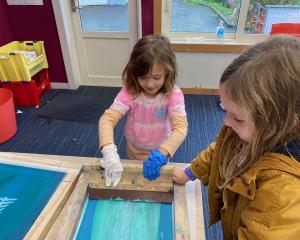 St Leonards School pupils (from left) Poppy Agate, 5, and Freyja Hill, 7, work on screen-printed...