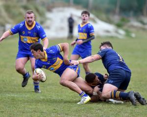 Dunedin forwards Hame Toma (centre) and Hunter Fahey (right) tackle Taieri’s Josh Whaanga during...