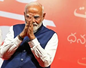 India’s Prime Minister Narendra Modi gestures at the Bharatiya Janata Party (BJP) headquarters to...