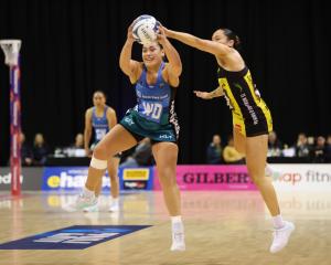 Southern Steel wing defence Renee Savai’inaea hangs on to the ball under the pressure of Central...