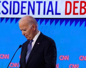 President Joe Biden listens as Republican candidate Donald Trump speaks during their debate in...