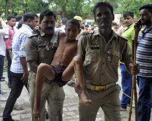 A boy, who was injured in a crowd crush at a religious gathering, is taken to a hospital for a...