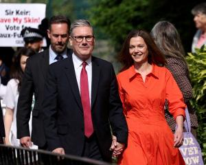 Britain's opposition Labour Party leader Keir Starmer and his wife Victoria walk outside a London...