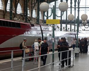 Police officers patrol Gare du Nord station after threats against France's high-speed TGV network...