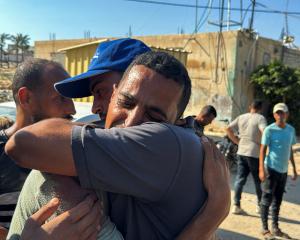 Palestinians mourn a relative killed in an Israeli strike in Khan Younis. PHOTO: REUTERS