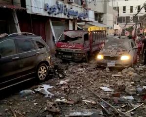 Damaged cars and buildings in Beirut following an Israeli drone strike. Photo: Reuters 