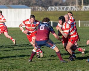 Clutha hooker Josh Turnbull runs into contact against West Taieri captain Conor Beaton during...