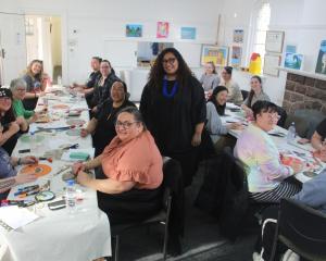 Ana Teofilo, standing centre, shares the art of carving Polynesian patterns to Southlanders at...