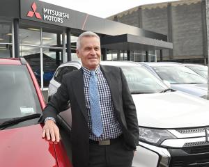 Dunedin car salesman Andrew Simms stands at a Mitsubishi dealership in Andersons Bay Rd which he...