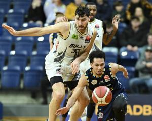 Franklin Bulls centre Sam Timmins and Otago Nuggets import Zaccheus Darko-Kelly chase a loose...