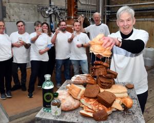 Sue Stockwell wrings out a loaf as Dunedin Craft Distillers celebrate saving 10tonnes of bread...