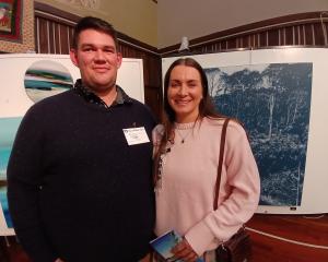 Josh and Aleisha Eden of Mandeville admire Audrey Anderson of Nelson’s ink on canvas exhibit....